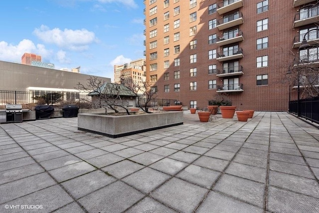 view of patio with a balcony and grilling area