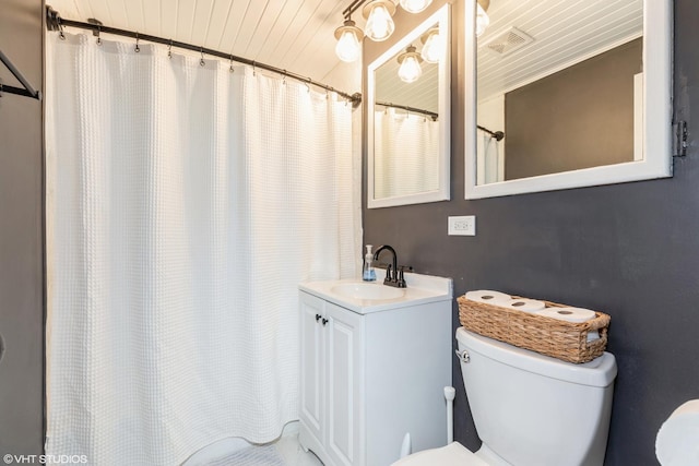 bathroom with curtained shower, visible vents, toilet, and vanity