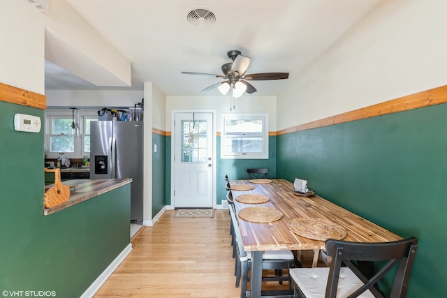 dining room with light wood-type flooring and ceiling fan