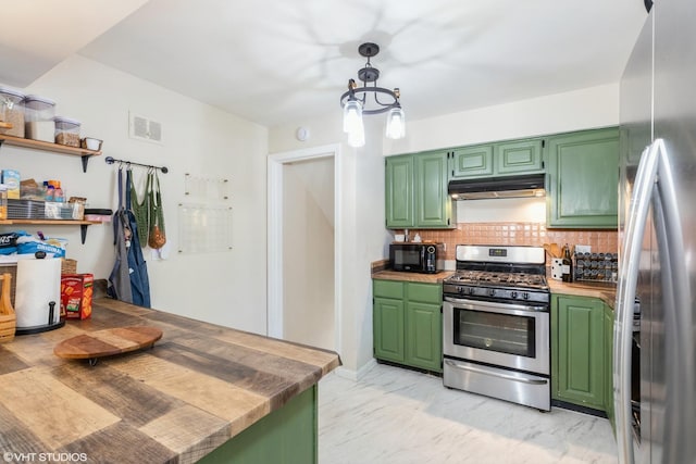 kitchen featuring decorative backsplash, stainless steel appliances, under cabinet range hood, decorative light fixtures, and green cabinetry