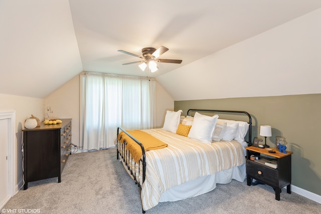 bedroom featuring vaulted ceiling, light carpet, and ceiling fan