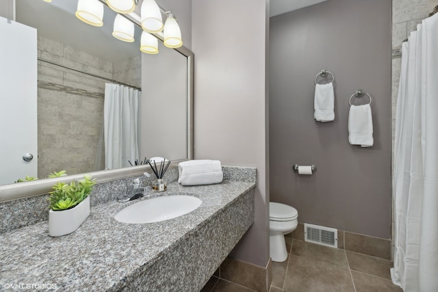 bathroom with tile patterned flooring, curtained shower, vanity, and toilet