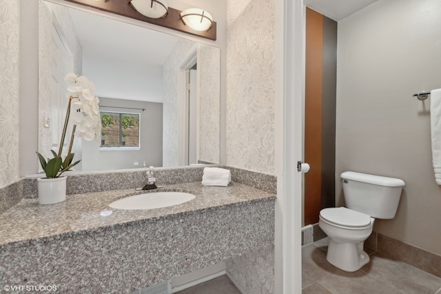 bathroom with tile patterned flooring, toilet, and vanity