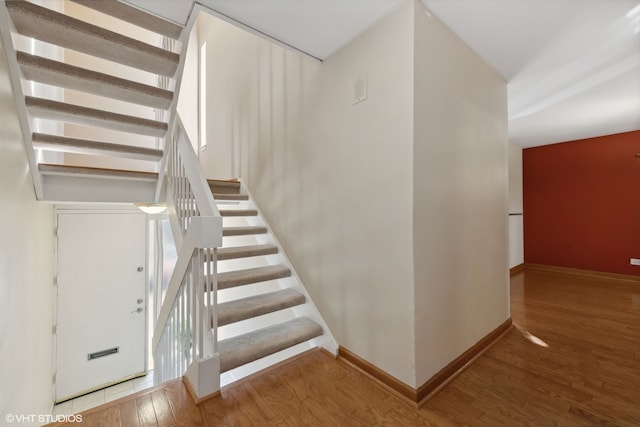 stairs featuring wood-type flooring