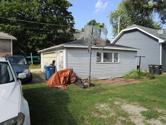 exterior space featuring a garage and a lawn