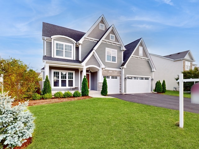 view of front of house featuring a garage and a front yard