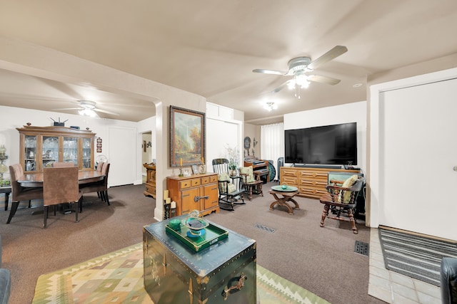 carpeted living room featuring ceiling fan