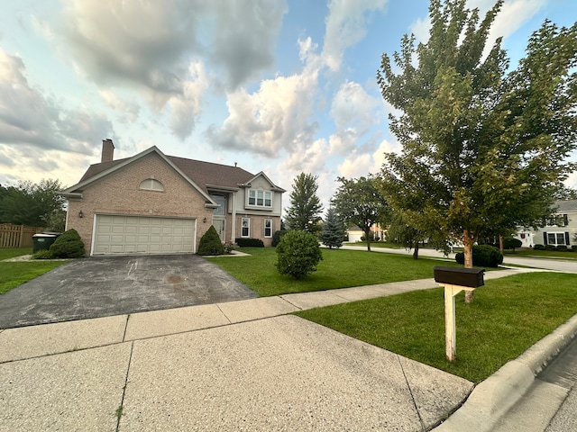 view of front of home featuring a garage and a front lawn