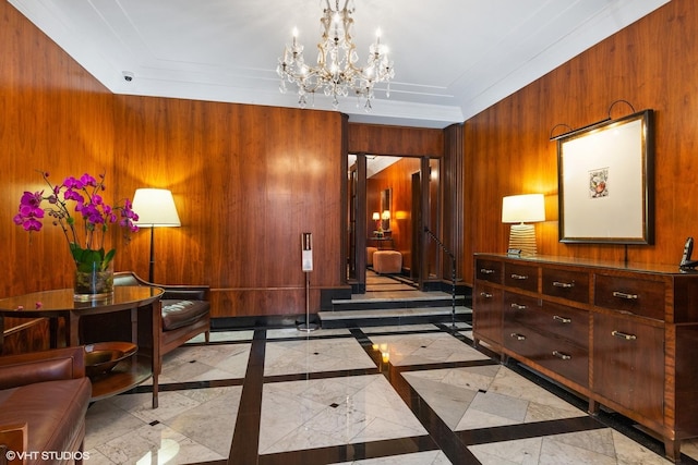 interior space featuring a notable chandelier, wooden walls, and ornamental molding