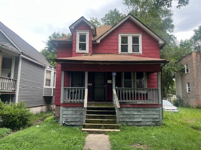 bungalow-style house featuring a front lawn and a porch