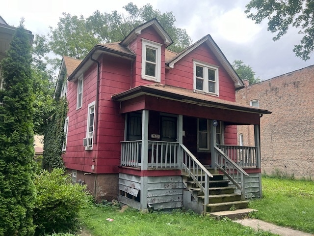 view of front of home with cooling unit and a porch