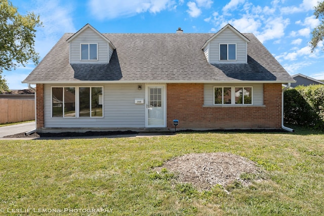 new england style home featuring a front lawn