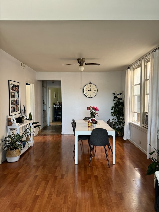 dining room with dark wood-type flooring and ceiling fan