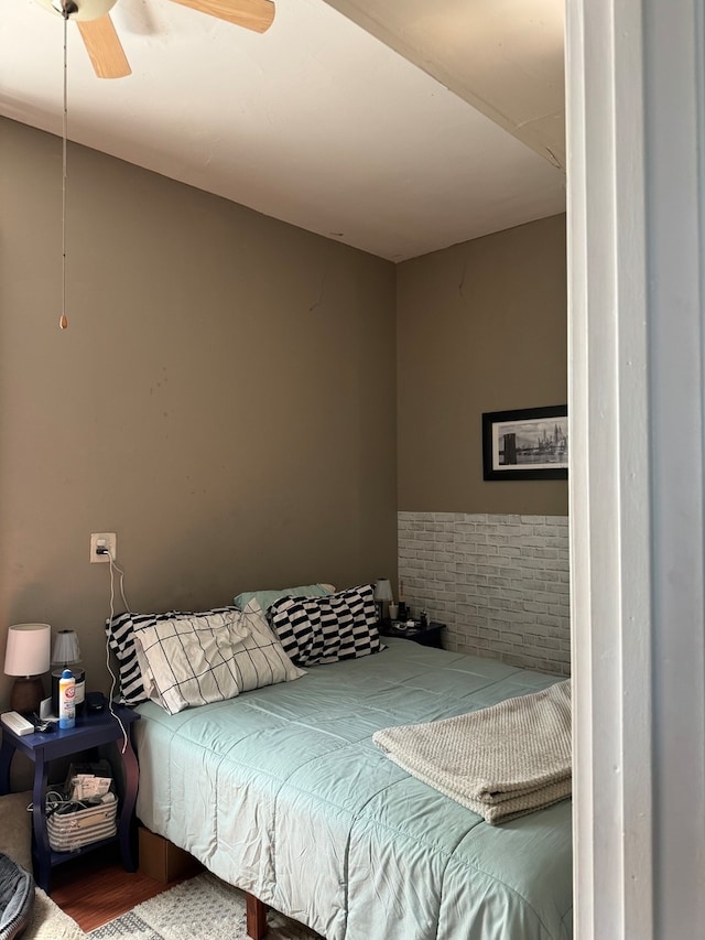 bedroom with ceiling fan and hardwood / wood-style flooring