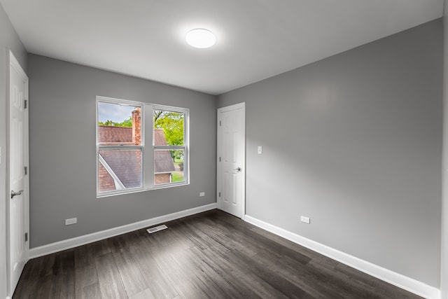 spare room with wood-type flooring