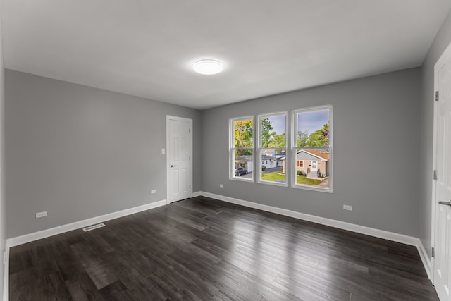 unfurnished room featuring dark wood-type flooring