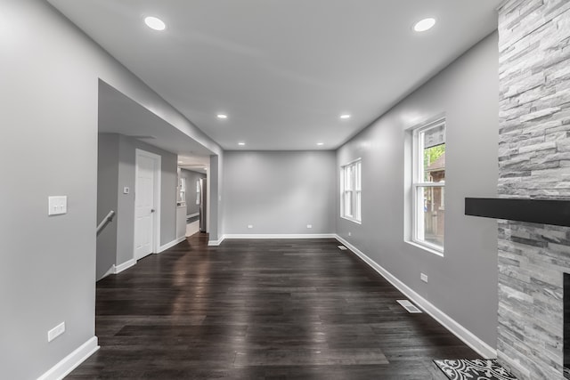 unfurnished living room featuring dark hardwood / wood-style floors