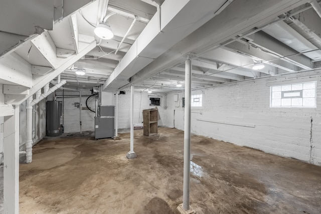 basement featuring gas water heater and heating unit