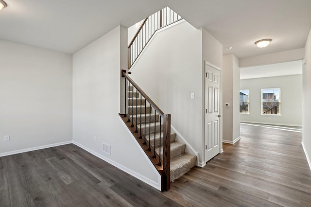 stairway with hardwood / wood-style floors