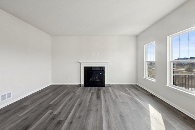 unfurnished living room with dark hardwood / wood-style floors