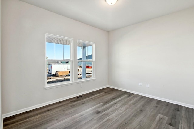 spare room featuring wood-type flooring