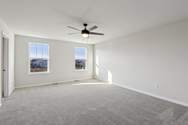 carpeted empty room featuring ceiling fan