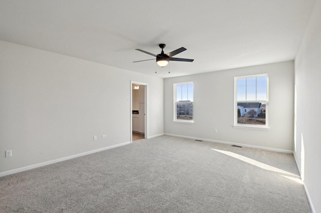 unfurnished room featuring light colored carpet and ceiling fan