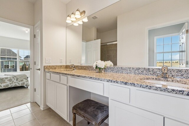 601 Virginia St, Elburn, IL 60119 - bathroom with tile patterned floors, a spacious closet, a tile shower, and vanity