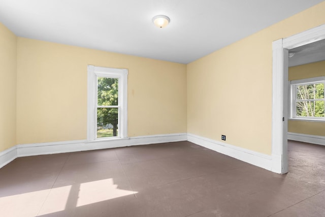unfurnished room featuring baseboards