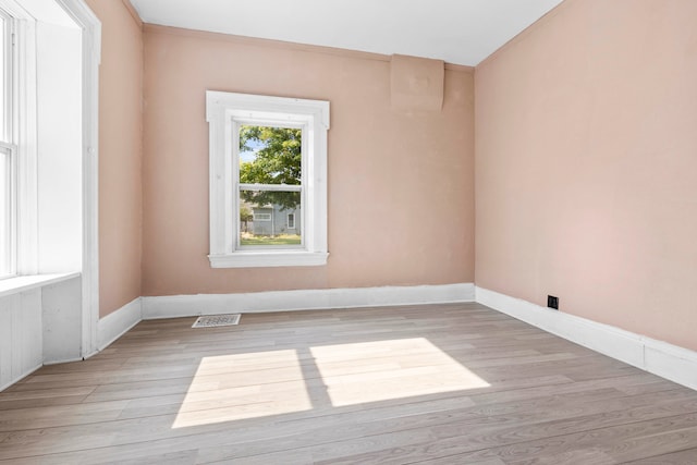 spare room with light hardwood / wood-style flooring