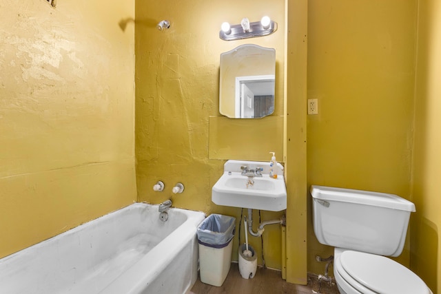 bathroom with wood-type flooring, a bathing tub, toilet, and sink