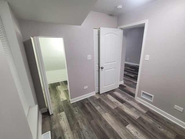 unfurnished bedroom with dark wood-type flooring