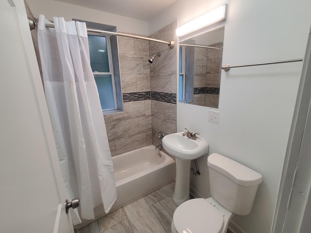 bathroom featuring toilet and shower / bath combo with shower curtain