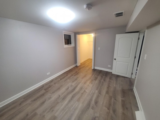 unfurnished room with hardwood / wood-style flooring