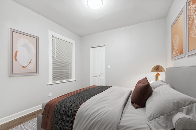 bedroom with hardwood / wood-style flooring and a closet