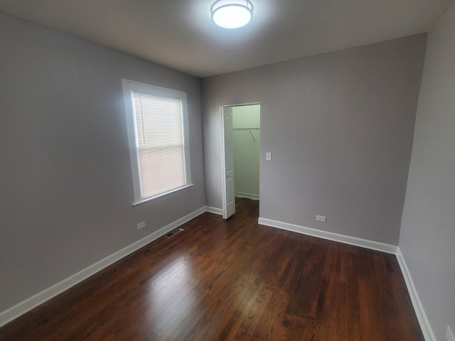 empty room featuring dark hardwood / wood-style flooring