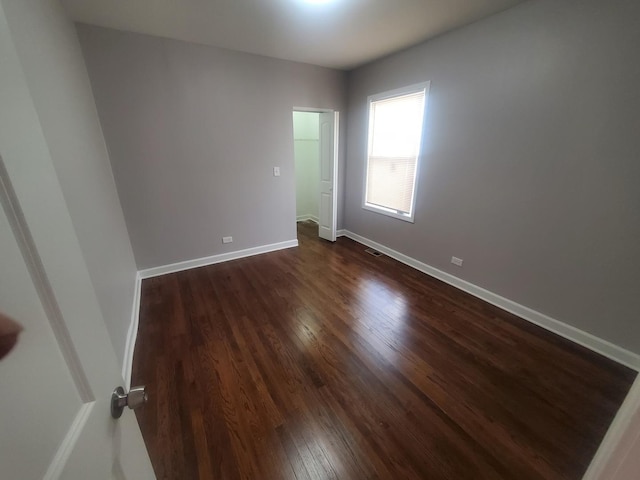 spare room with dark hardwood / wood-style flooring