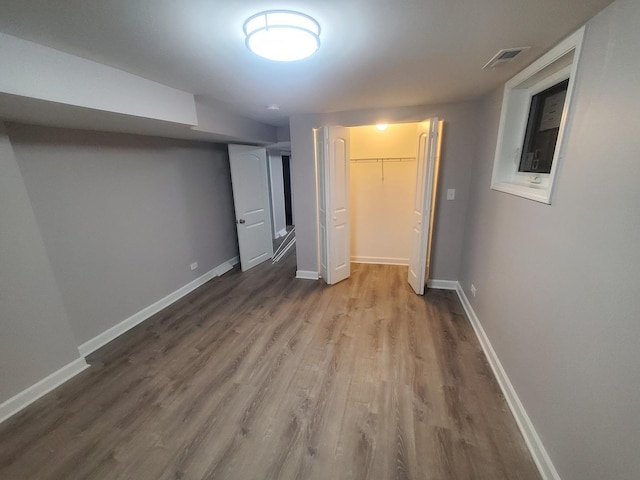 unfurnished bedroom with a closet and wood-type flooring