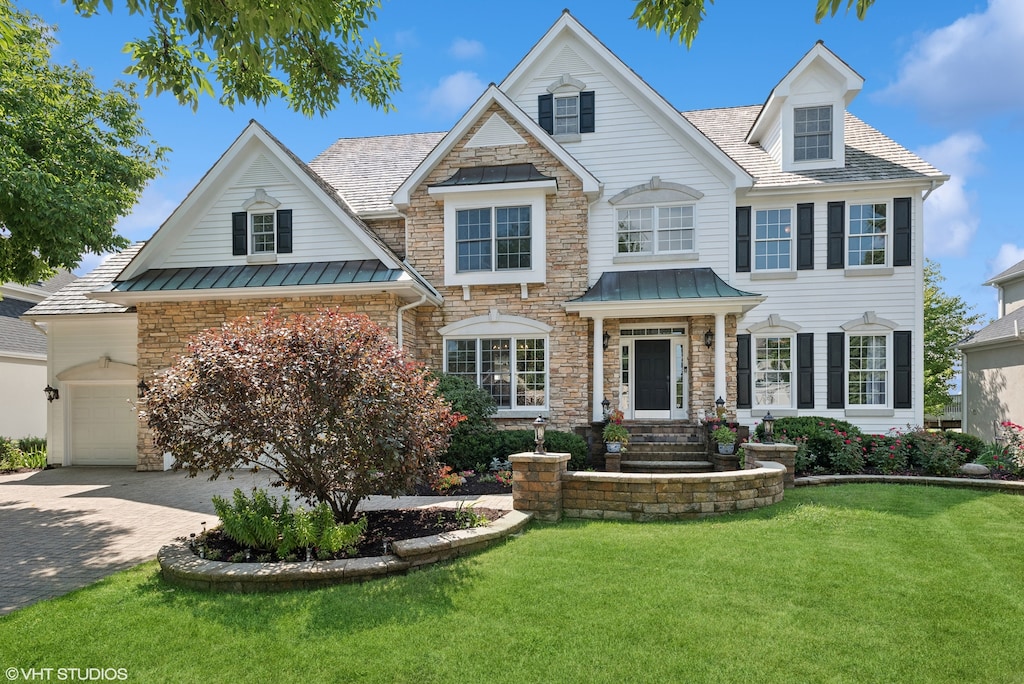 view of front of property with a garage and a front yard