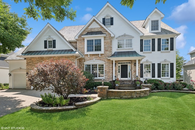 view of front of property with a garage and a front yard