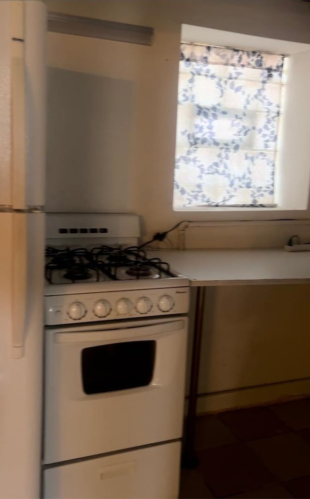 kitchen with white range with gas stovetop