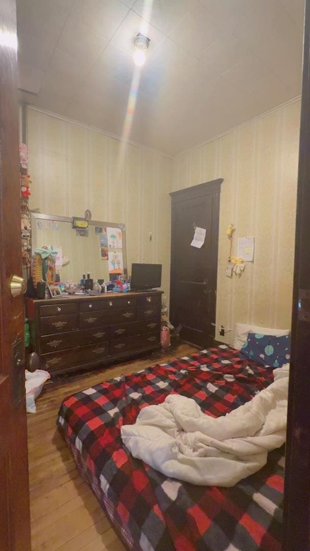 bedroom featuring wood finished floors