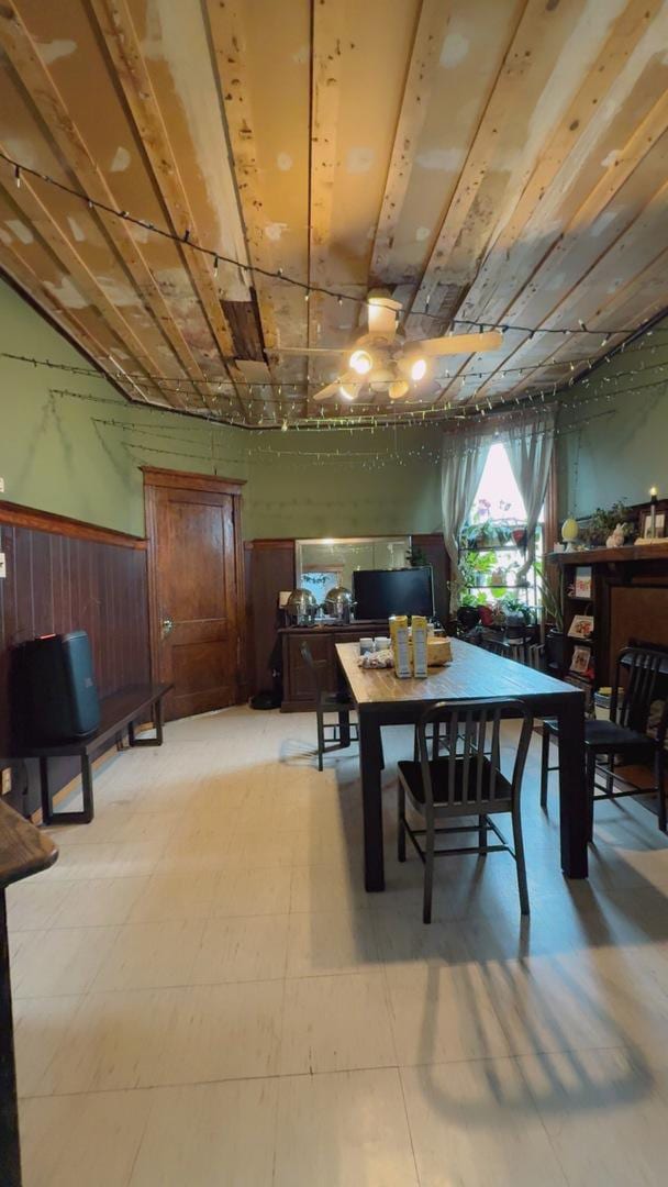 dining room with light floors and wainscoting