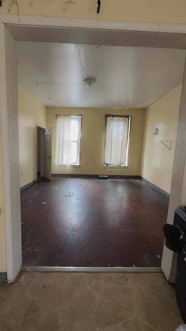 unfurnished room featuring baseboards