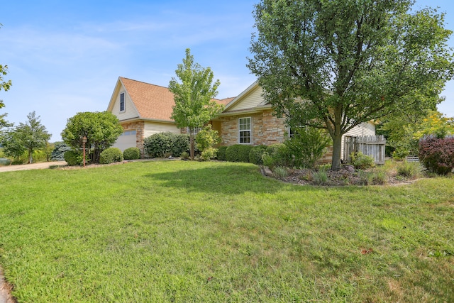 view of front of property with a garage and a front yard