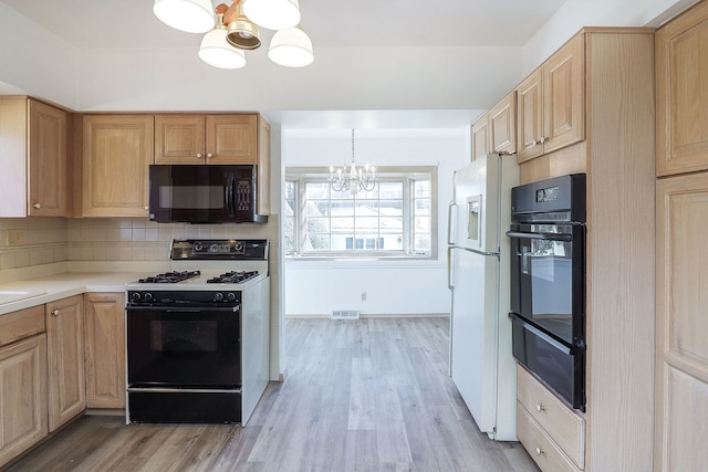 kitchen featuring black appliances, tasteful backsplash, light hardwood / wood-style floors, light brown cabinetry, and a notable chandelier