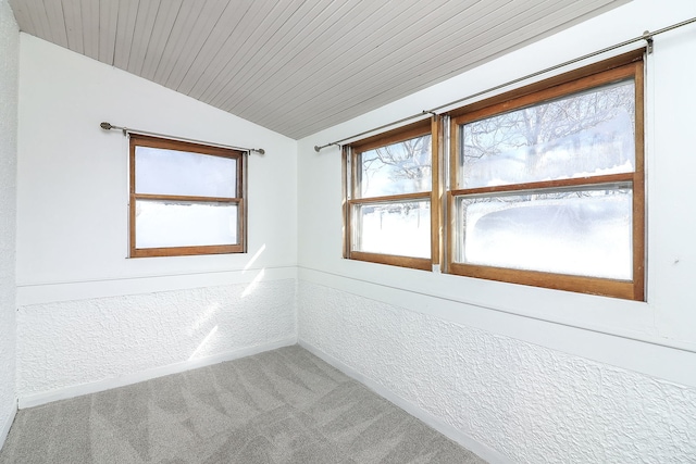 carpeted spare room with wood ceiling and lofted ceiling