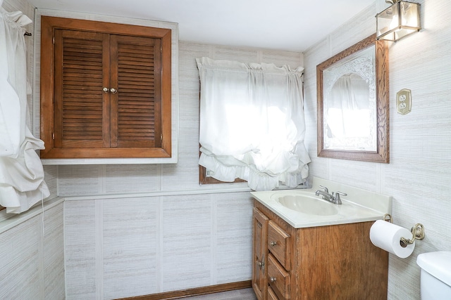 bathroom featuring toilet and vanity