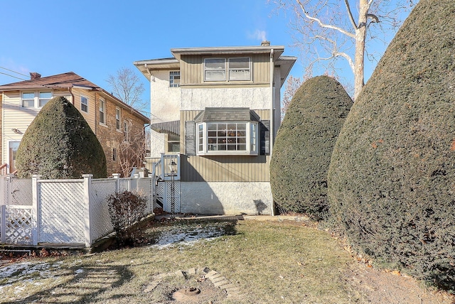 rear view of property with a yard