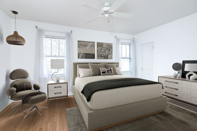 bedroom with ceiling fan, dark wood-type flooring, and multiple windows